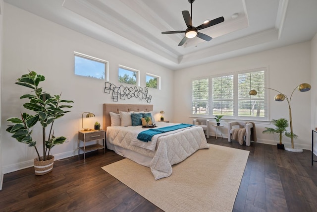 106 Gabriel Woods Dr, Georgetown, TX 78633 - bedroom featuring a tray ceiling, dark wood-type flooring, ornamental molding, and ceiling fan
