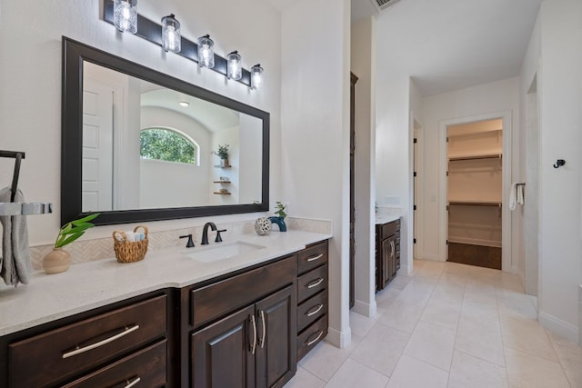 106 Gabriel Woods Dr, Georgetown, TX 78633 - full bath featuring vanity, a spacious closet, and tile patterned floors