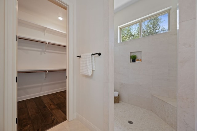 106 Gabriel Woods Dr, Georgetown, TX 78633 - full bath with a walk in shower, a spacious closet, and wood finished floors