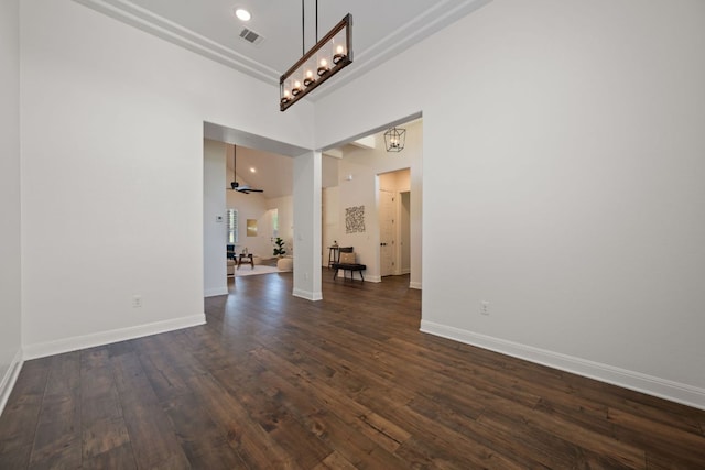 106 Gabriel Woods Dr, Georgetown, TX 78633 - unfurnished room with dark wood-type flooring, baseboards, a chandelier, and a high ceiling