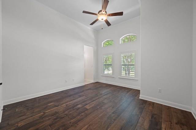106 Gabriel Woods Dr, Georgetown, TX 78633 - unfurnished room featuring crown molding, baseboards, ceiling fan, dark wood-style floors, and a high ceiling