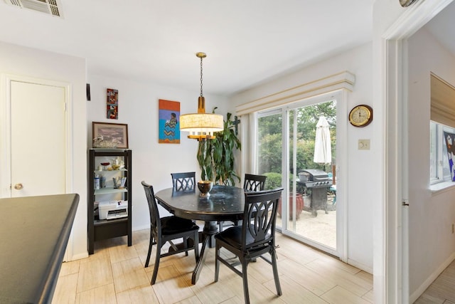 dining room with baseboards and a chandelier