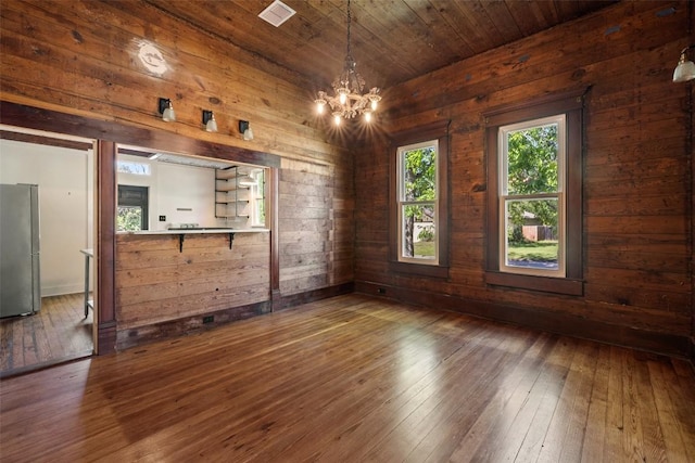 1019 W 4th St, Taylor, TX 76574 - unfurnished dining area featuring wooden walls, dark wood-style floors, a chandelier, and wood ceiling