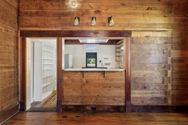 1019 W 4th St, Taylor, TX 76574 - spare room featuring wooden walls and wood finished floors
