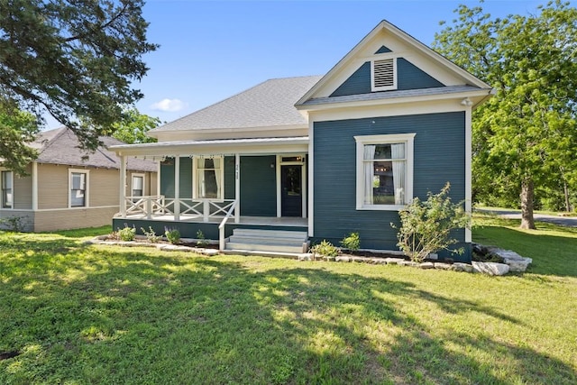 1019 W 4th St, Taylor, TX 76574 - rear view of house with a porch and a yard