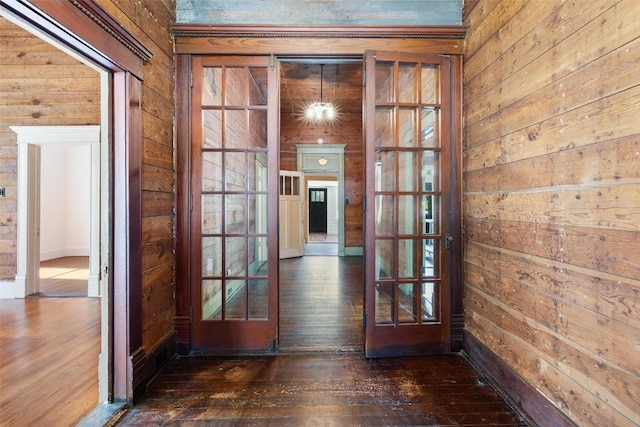 1019 W 4th St, Taylor, TX 76574 - entryway with hardwood / wood-style flooring and wood walls