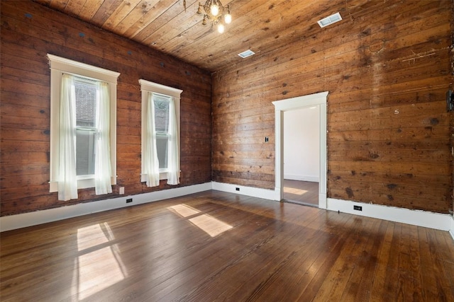 1019 W 4th St, Taylor, TX 76574 - unfurnished room featuring wood-type flooring, wooden ceiling, wood walls, and baseboards