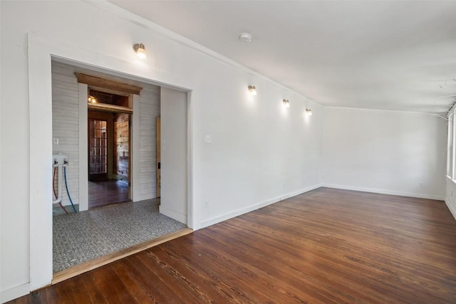 1019 W 4th St, Taylor, TX 76574 - spare room with wood finished floors, a smoke detector, baseboards, french doors, and ornamental molding