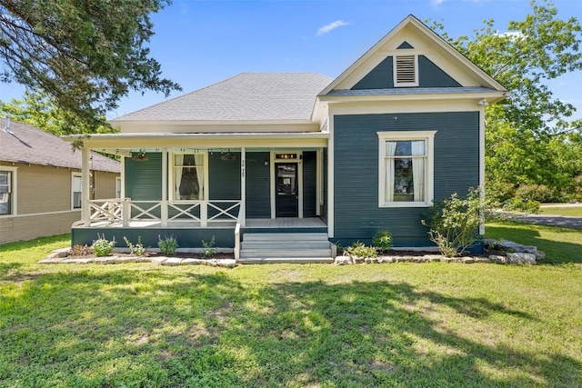 1019 W 4th St, Taylor, TX 76574 - back of house featuring covered porch and a lawn