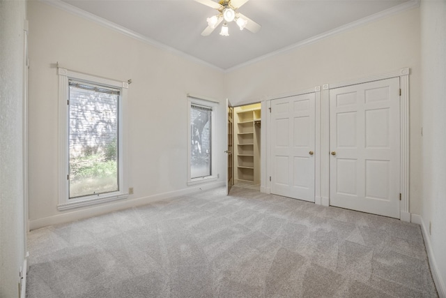 10242 Pinehurst Dr, Austin, TX 78747 - unfurnished bedroom featuring crown molding, carpet flooring, two closets, and ceiling fan