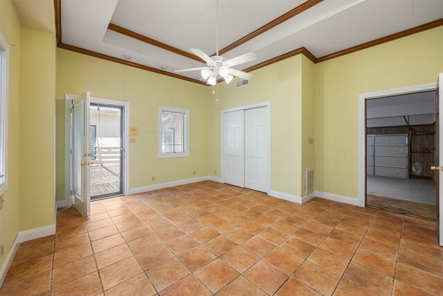 10242 Pinehurst Dr, Austin, TX 78747 - unfurnished bedroom with ornamental molding, a closet, a tray ceiling, a ceiling fan, and light tile patterned flooring