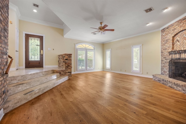 10242 Pinehurst Dr, Austin, TX 78747 - unfurnished living room featuring a fireplace, a ceiling fan, light wood-type flooring, crown molding, and baseboards