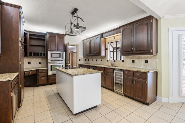 10242 Pinehurst Dr, Austin, TX 78747 - kitchen featuring wine cooler, appliances with stainless steel finishes, a sink, backsplash, and dark brown cabinetry