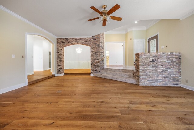 10242 Pinehurst Dr, Austin, TX 78747 - unfurnished living room with arched walkways, wood finished floors, a ceiling fan, crown molding, and baseboards