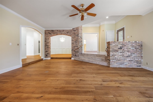 10242 Pinehurst Dr, Austin, TX 78747 - unfurnished living room with arched walkways, wood finished floors, ceiling fan, ornamental molding, and recessed lighting