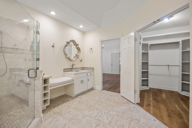 10242 Pinehurst Dr, Austin, TX 78747 - full bath with a walk in closet, a stall shower, vanity, wood finished floors, and recessed lighting