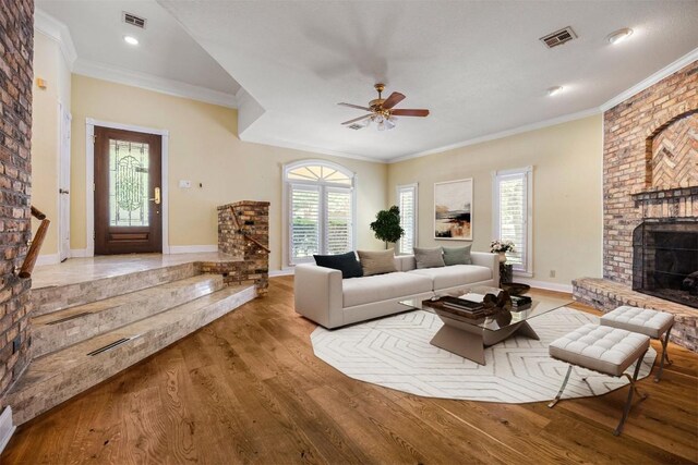 10242 Pinehurst Dr, Austin, TX 78747 - living area with a fireplace, wood finished floors, ceiling fan, crown molding, and baseboards