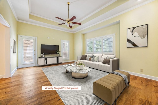 10242 Pinehurst Dr, Austin, TX 78747 - living room featuring a raised ceiling, ceiling fan, ornamental molding, and wood finished floors