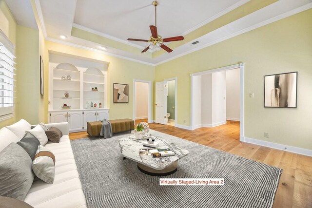 10242 Pinehurst Dr, Austin, TX 78747 - living area featuring light wood-type flooring, ceiling fan, ornamental molding, and a tray ceiling
