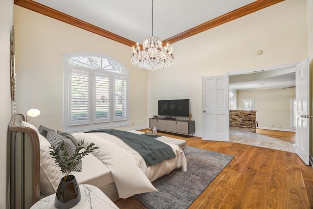 10242 Pinehurst Dr, Austin, TX 78747 - bedroom featuring a chandelier, wood finished floors, multiple windows, and ornamental molding
