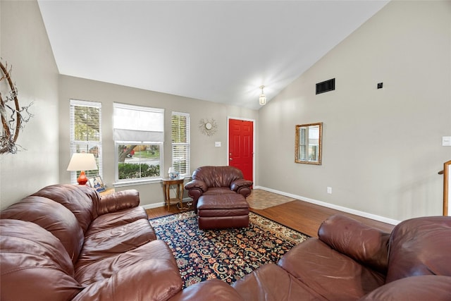 living area featuring wood finished floors, baseboards, and high vaulted ceiling