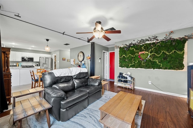 1610 Plume Grass Pl, Round Rock, TX 78665 - living room with a ceiling fan, wood finished floors, and baseboards