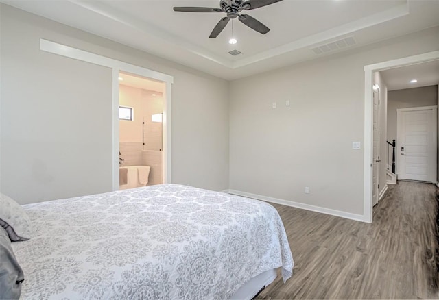 171 Eely Rd, Mcdade, TX 78650 - bedroom with a raised ceiling, wood finished floors, recessed lighting, baseboards, and ensuite bathroom