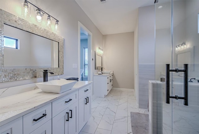 171 Eely Rd, Mcdade, TX 78650 - bathroom featuring marble finish flooring, two vanities, a stall shower, and baseboards