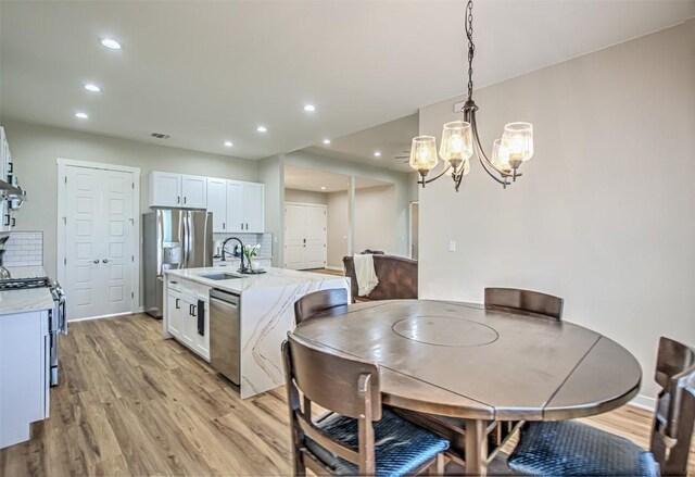 171 Eely Rd, Mcdade, TX 78650 - dining space with light wood-type flooring, a chandelier, and recessed lighting