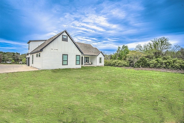 171 Eely Rd, Mcdade, TX 78650 - back of house with board and batten siding and a lawn