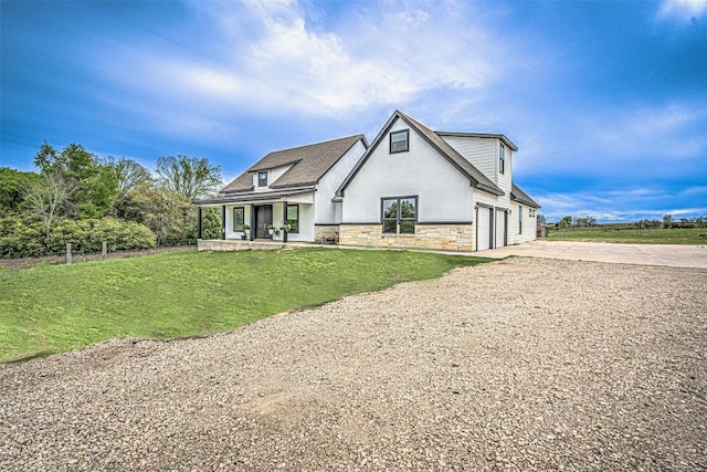 171 Eely Rd, Mcdade, TX 78650 - view of front of property with stone siding, driveway, a front yard, a porch, and stucco siding