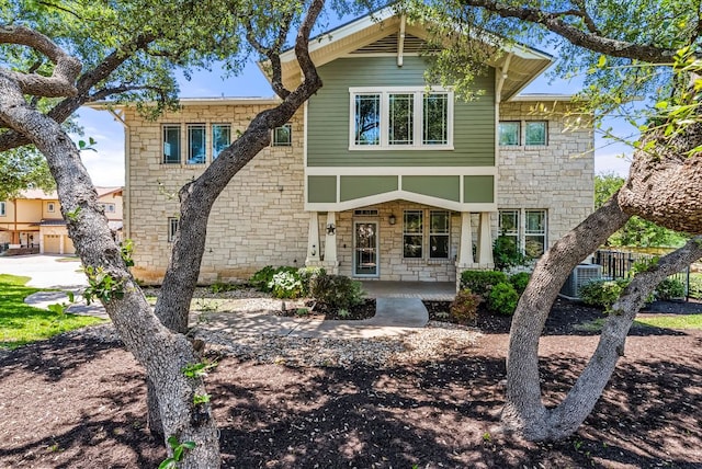 2930 Grand Oaks Loop Unit 401, Cedar Park, TX 78613 - view of front facade featuring stone siding and central air condition unit