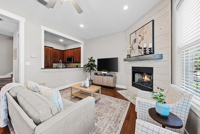 2930 Grand Oaks Loop Unit 401, Cedar Park, TX 78613 - living area featuring a ceiling fan, a tile fireplace, recessed lighting, dark wood finished floors, and baseboards