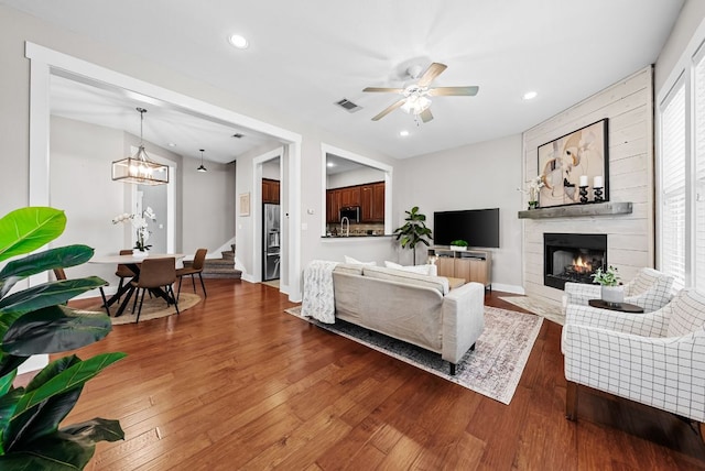 2930 Grand Oaks Loop Unit 401, Cedar Park, TX 78613 - living area with stairway, wood finished floors, a fireplace with flush hearth, recessed lighting, and a ceiling fan