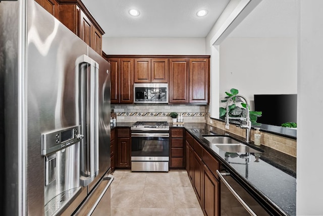 2930 Grand Oaks Loop Unit 401, Cedar Park, TX 78613 - kitchen featuring appliances with stainless steel finishes, a sink, dark stone counters, tasteful backsplash, and recessed lighting