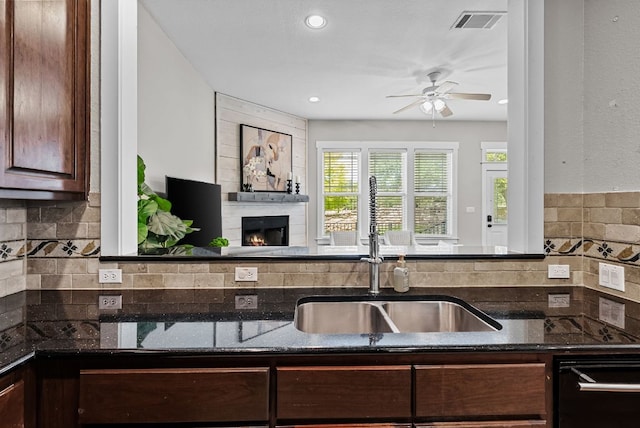 2930 Grand Oaks Loop Unit 401, Cedar Park, TX 78613 - kitchen with a sink, a ceiling fan, backsplash, dishwasher, and dark stone counters