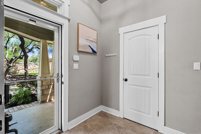 2930 Grand Oaks Loop Unit 401, Cedar Park, TX 78613 - doorway with light tile patterned floors and baseboards