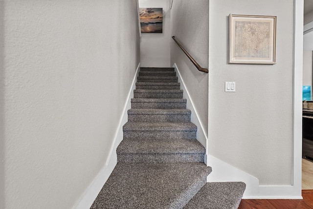 2930 Grand Oaks Loop Unit 401, Cedar Park, TX 78613 - stairway featuring a textured wall, wood finished floors, and baseboards