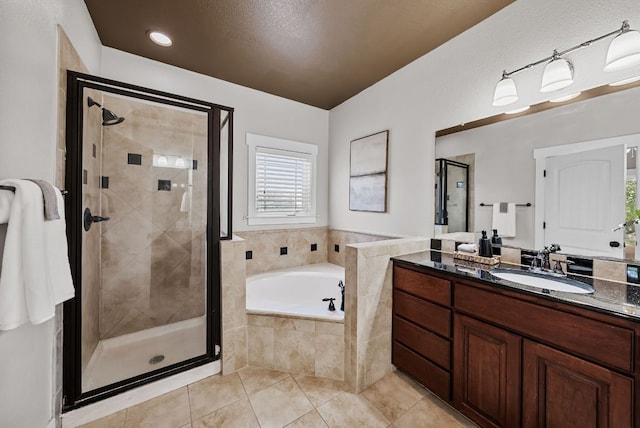 2930 Grand Oaks Loop Unit 401, Cedar Park, TX 78613 - bathroom featuring a bath, a shower stall, tile patterned floors, and vanity