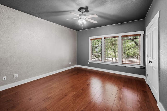 2930 Grand Oaks Loop Unit 401, Cedar Park, TX 78613 - unfurnished room featuring a textured wall, ceiling fan, dark wood-style flooring, baseboards, and a textured ceiling