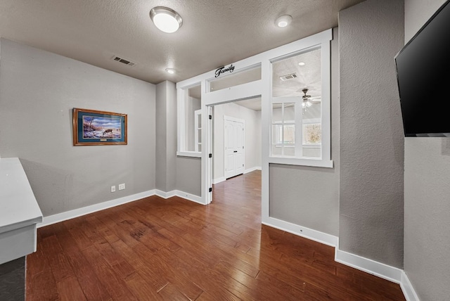 2930 Grand Oaks Loop Unit 401, Cedar Park, TX 78613 - hall featuring hardwood / wood-style flooring, baseboards, a textured ceiling, and a textured wall