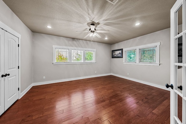 2930 Grand Oaks Loop Unit 401, Cedar Park, TX 78613 - unfurnished bedroom with a textured ceiling, wood finished floors, a ceiling fan, baseboards, and recessed lighting