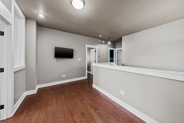 2930 Grand Oaks Loop Unit 401, Cedar Park, TX 78613 - empty room featuring dark wood-style floors, baseboards, and a textured ceiling