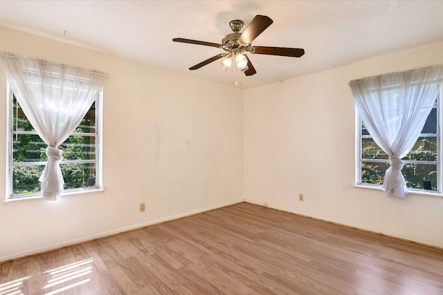 6009 Belfast Dr, Austin, TX 78723 - empty room with light wood-style floors, baseboards, and a ceiling fan