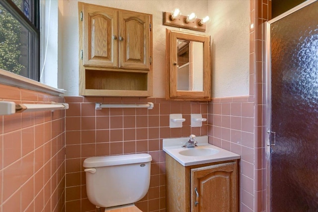 6009 Belfast Dr, Austin, TX 78723 - bathroom featuring a stall shower, toilet, tile walls, and vanity