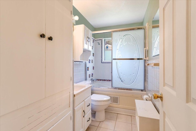 6009 Belfast Dr, Austin, TX 78723 - full bath featuring toilet, tile patterned floors, combined bath / shower with glass door, and vanity