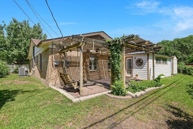 6009 Belfast Dr, Austin, TX 78723 - view of front of home with a pergola, a front lawn, a patio, central AC unit, and brick siding