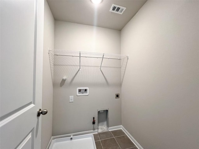 431 Ferrule Dr, Kyle, TX 78640 - laundry area with hookup for a gas dryer, hookup for a washing machine, hookup for an electric dryer, and dark tile patterned floors
