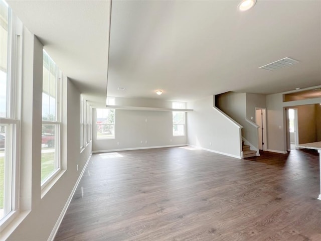 431 Ferrule Dr, Kyle, TX 78640 - unfurnished living room featuring wood finished floors, baseboards, and stairs
