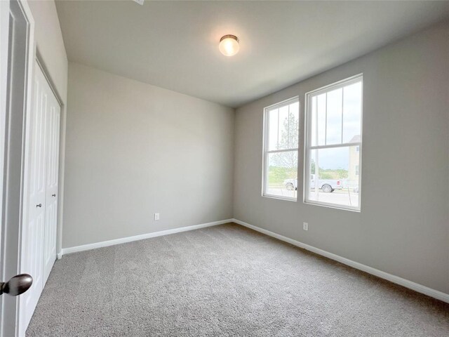 431 Ferrule Dr, Kyle, TX 78640 - unfurnished bedroom with carpet flooring, baseboards, and a closet